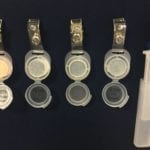 Several opened Assay Technology air monitoring badges.